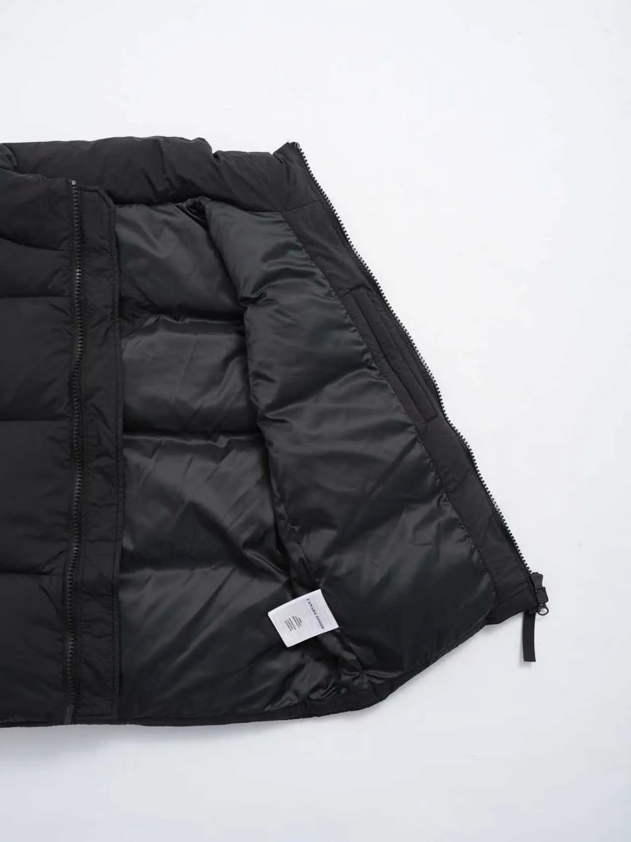 P580 Canada gooes Lawrence Down Vest (high version) With a durable shell and quilted body, the Lawrence Down Vest is a must-have for all seasons. The fabric has a durable soft touch. Longer hem at back for added protection. Reflective double-stripe grip tape at back. The Lawrence features an engineered down-filled collar to block strong winds, a two-way front zip and a longer rear hem. Color: black with red label, black with black label, desert color, ocean blue Size: XS -2XL